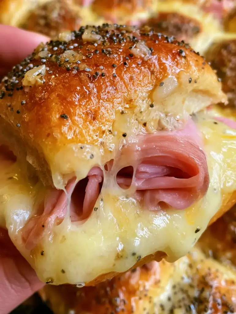 Extreme Nahaufnahme eines frischen Hawaiian Sliders mit Honigschinken und geschmolzenem Schweizer Käse unter einem Brioche-Brötchen. (hawaiian slider)